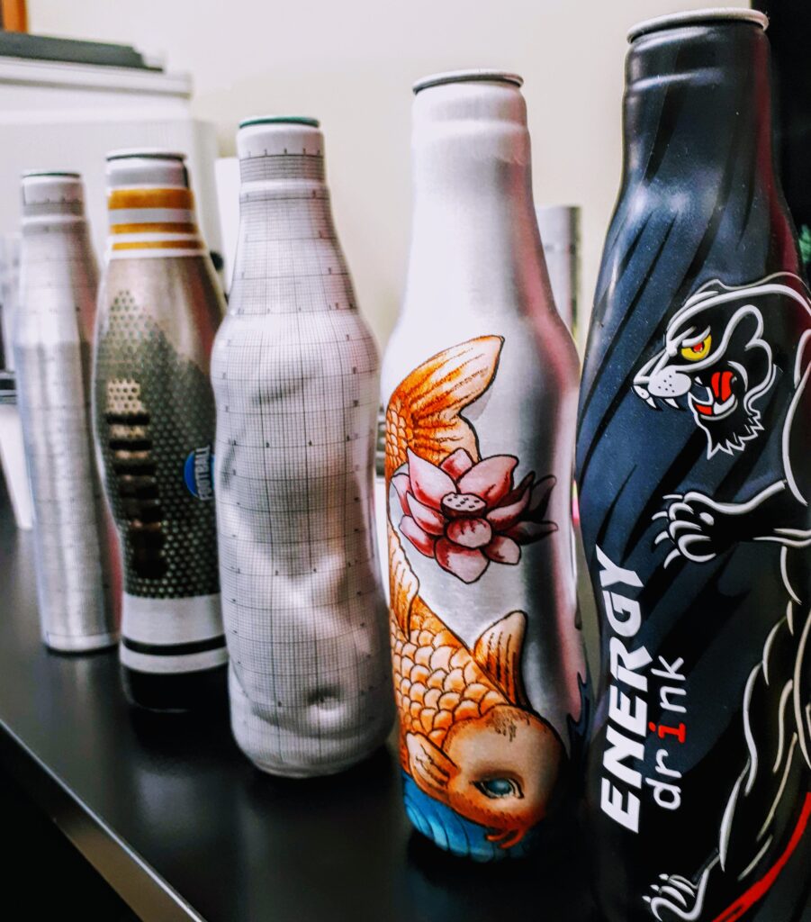 Custom shaped aluminum beer bottles in five different profiles, including grid-mapped development prototypes and finished printed designs