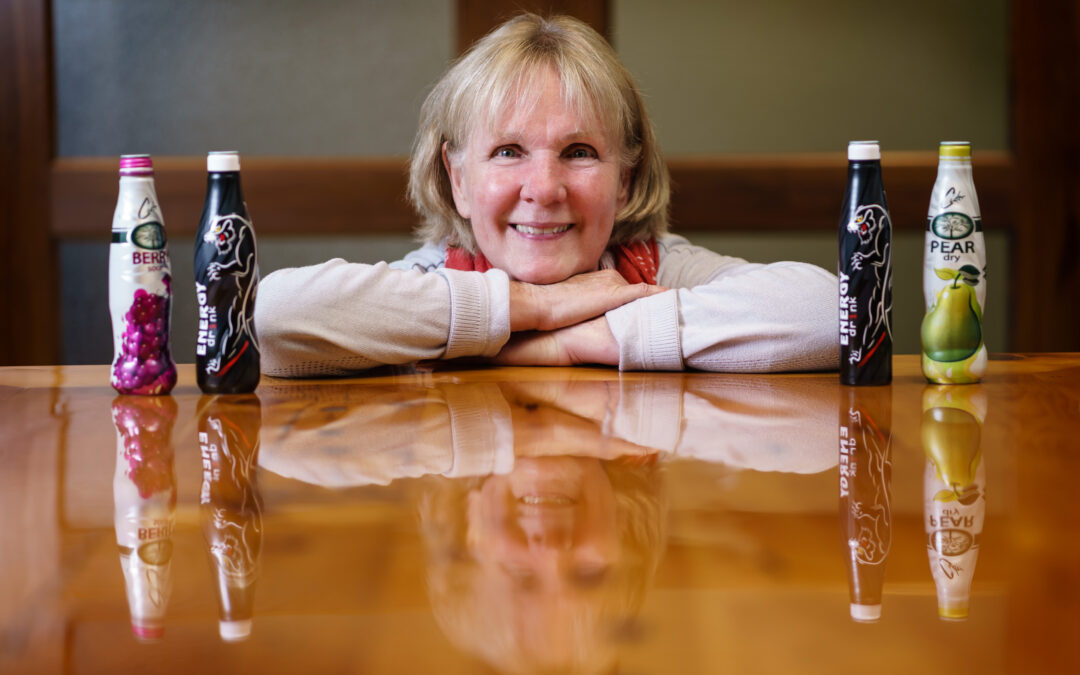 KAT custom aluminum beverage bottles displayed with Betty Pilon of Kingston Aluminum Technology