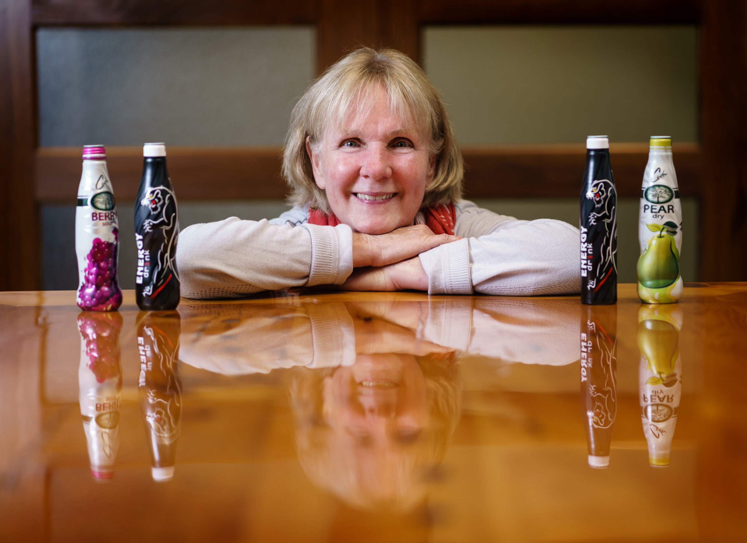 Custom aluminum bottles by KAT — berry, energy drink, and pear-dry beverage bottles with full-wrap printing